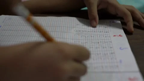 Close up of kid writing and learning at home during covid 19 pandemic Video stock 143060621