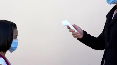 Close up kids checking body temperature by infrared thermometer in hand holding  Stock-Footage 132350778