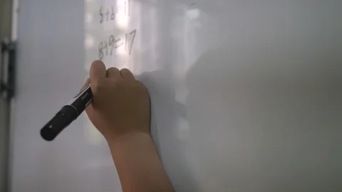 Close-up of kid's hand cracking a math equation Stock-Footage 122509910