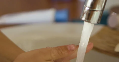 Close-up of kid's hand under stream of water in bathroom in slow motion Stock Footage 66063854