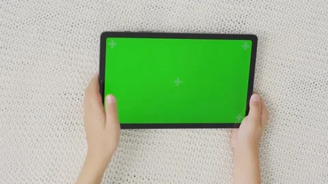 Close up kids hands holding, tapping on a tablet with green screen. Mock up Stock-Footage 257012698