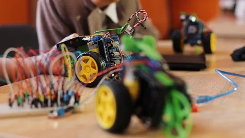 Close up of kids hands playing with robot machines and toys on the classroom Stock Footage 82475125