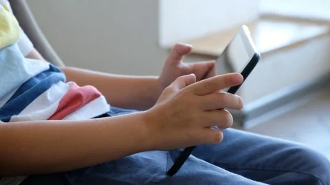 Close up of kid's hands playing on tablet pc Stock Footage 116657139
