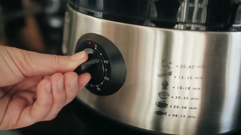 Close up of kitchen appliances timer. Person turn on double boiler. Stock Footage 233006057