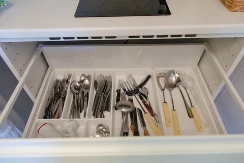 Close up of a kitchen drawer full of various utensils Stock Photos