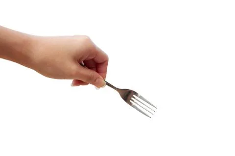 Close up of kitchen fork in hand. Isolated on a white background. Stock Photos