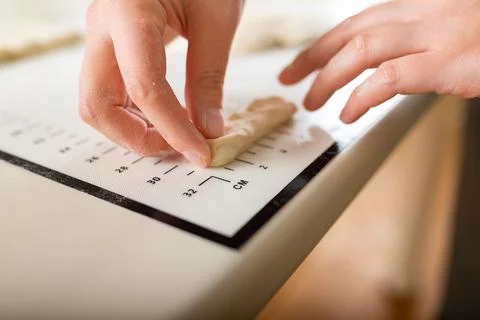 Close-up on a kitchen silicone baking mat with markings as a helper in the Stock Photos