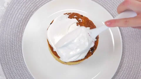 Close-up. A kitchen spatula smears icing on delicious Orthodox Easter bread, a Stock Footage 169415239