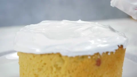 Close-up. A kitchen spatula smears icing on delicious Orthodox Easter bread, a Stock Footage 169649593