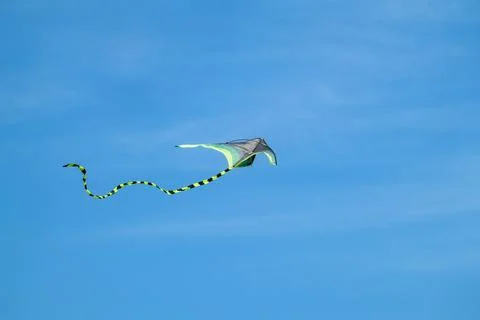 Close-up of kite flying in bright blue sky Stock Photos