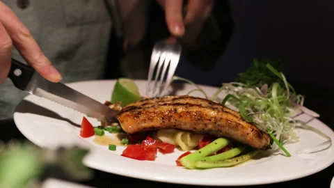 Close up of knife cuts baked salmon. Stock Footage 276593162