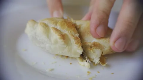 Close up of a knife cutting a recently baked warm empanada. Argentina Stock Footage 148052902