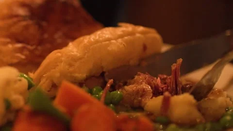Close Up of Knife Cutting Into Savoury Steak Pie with Vegetables Stock Footage 326410710