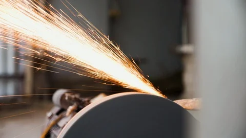 Close up of knife maker sharpening flat piece of steel for knife blade Stock Footage 147371609