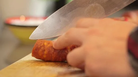 Close up of knife scoring Chorizo and male hands peeling Stock-Footage 79836136