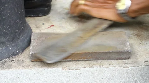 Close-up on a knife sharpener whetting a cleaver on the sidewalk Stock-Footage 67483684