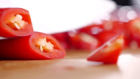 Close-up of Knife slice red chili pepper on cutting board. Shot in 4K Stock Footage 127801601
