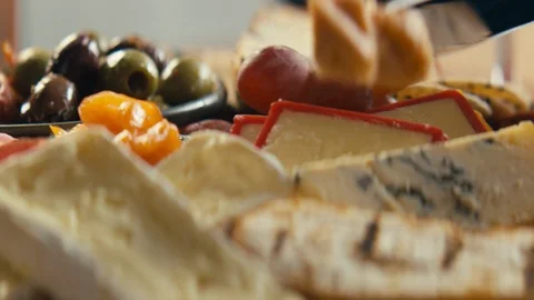 Close up of knife spreading hummus onto warm crunchy bread Stock Footage 89993916