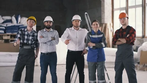 Close-knit team of construction engineers at a construction site making a hand Video stock 136358032