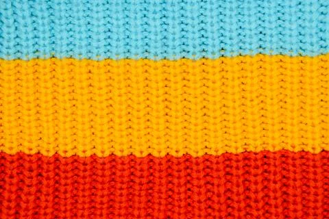 Close-up of knitted cotton texture - three wide horizontal stripes of blue, y Stock Photos