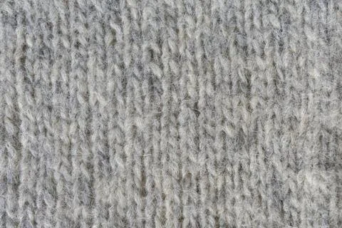 Close-up of knitted gray woolen texture. Knitted fabrics. Background of a Stock Photos