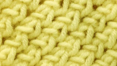 Close up of knitted product of woolen light threads, rotation in circle. Stock Footage 234119637