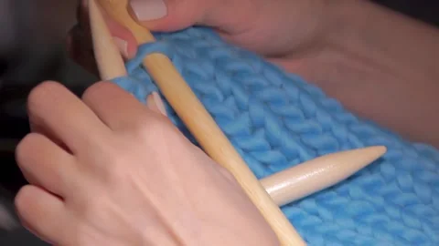 Close-up knitting a cap of wool yarn Stock Footage 98396760