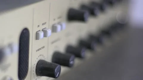 Close up of knobs and switches on a audio recording device. A headphone 動画素材 143383790