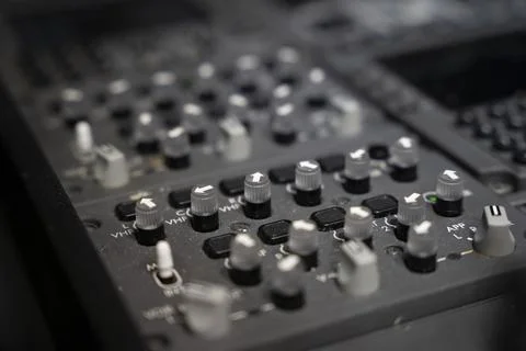 Close up on knobs of a commercial airplane radio panel. Stock Photos