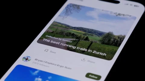 Close-up of the Komoot app being opened from a smartphone home screen and Stock Footage 334062975