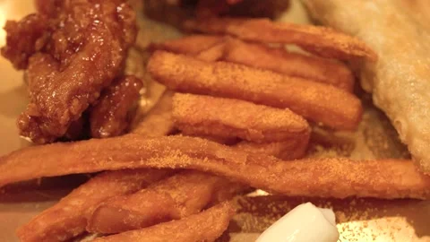 Close Up of Korean Fried Chicken and French Fries on Brass Plate Stock Footage 340378591