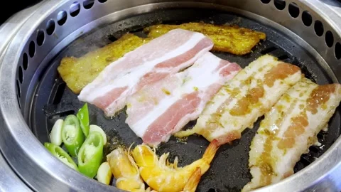 Close Up Korean Style Pork BBQ Grilling on Hot Pan Stock Footage 340413376