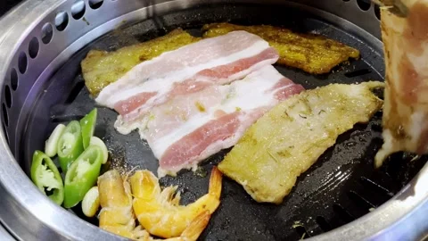 Close Up Korean Style Pork BBQ Grilling on Hot Pan Stock Footage 340413382