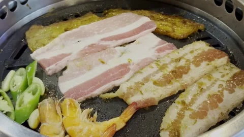 Close Up Korean Style Pork BBQ Grilling on Hot Pan Stock Footage 340413436