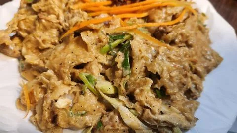 Close-up of kothu roti with shredded flatbread and spices served on plate. Stock Photos