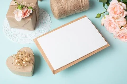 Close-up of a kraft envelope on the background of a gift and a bouquet of bus Stock Photos