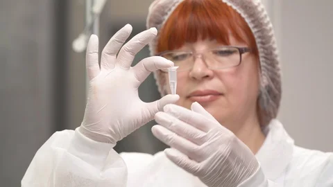 A close-up of lab technician holding a mini test tube with human biological Stock Footage 108548660