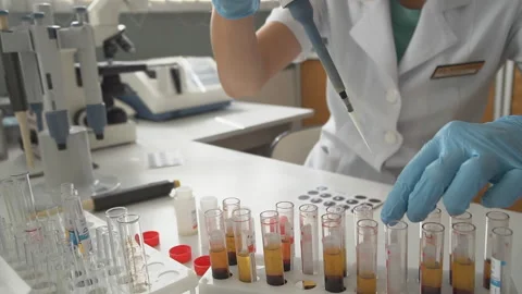 Close up.Lab technician looking through a microscope,close-up shot Stock Footage 95550956