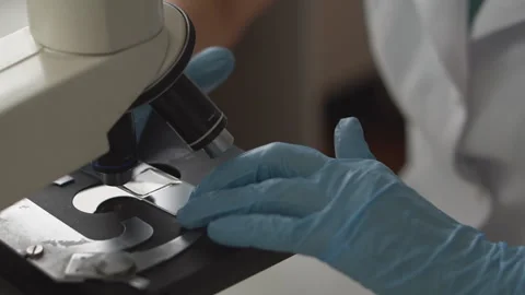 Close up.Lab technician looking through a microscope,close-up shot Stock Footage 95551419