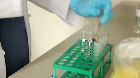 Close up.Lab technician looking through a microscope,close-up shot. Test covid Stock Footage 130929466