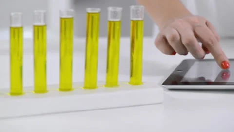 Close up of lab technician using touch screen on tablet computer Vídeo Stock 199630163
