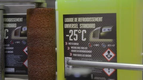 Close Up Label Applicator Roller Coolant Bottle Factory Stock Footage 335981310