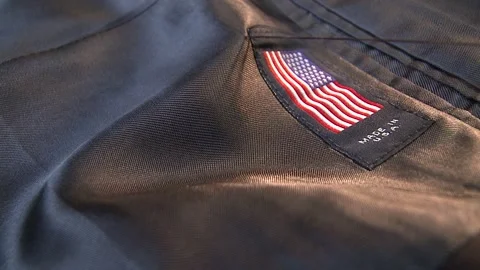A Close-up of a label being sewn onto the inside of a suit jacket Stock Footage 311924542