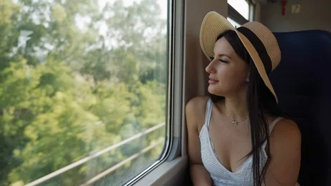 Close-up lady portrait in straw hat sitting next to the window and travelling by Stock Footage 112301535