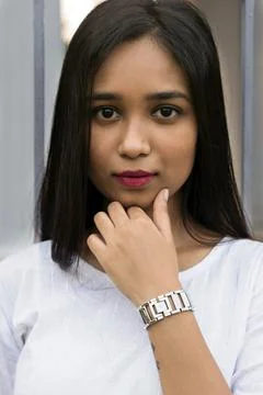 Close-up of lady staring in the camera with hand under chin. Stock Photos