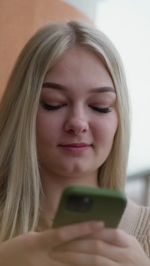Close-up of lady using iphone with green case in casual setting Stock Footage 318226948