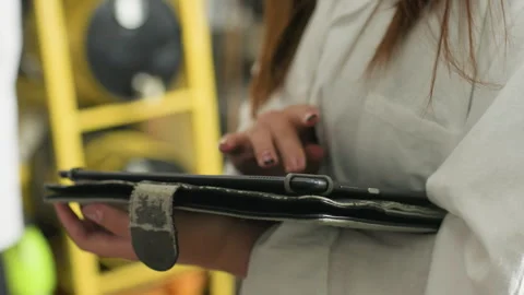 Close-Up of Lady Using Tablet in Mechanical Workshop Stock Footage 302195740