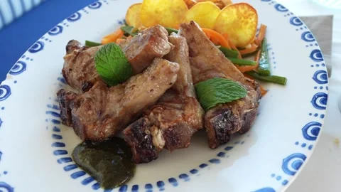 Close up of lamb chops with sweet potatoes and vegetables, nicely presented. Stock Footage 301367438