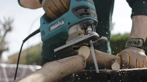 Close up of lamber man's hands sawing firewood with jigsaw Stock Footage 172268879