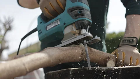 Close up of lamber man's hands sawing firewood with jigsaw Stock Footage 172376823